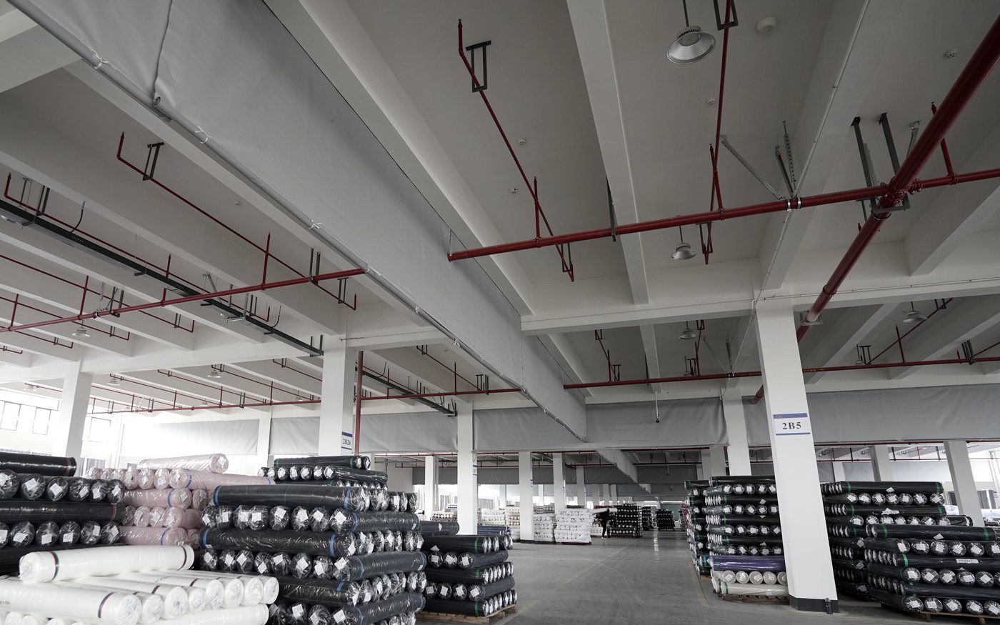 Raw material rolls stored in an anonymous factory area